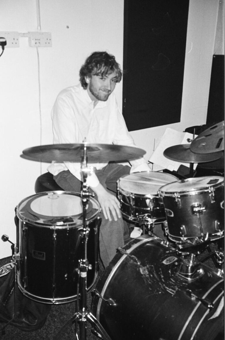 Oscar Williams sitting behind drum kit
